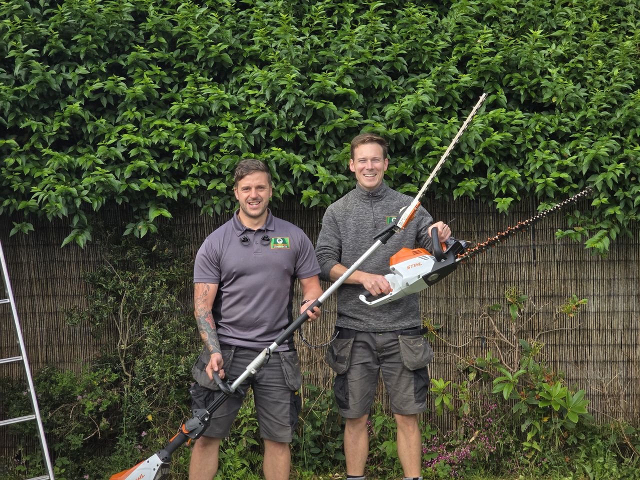 Two of the Edinburgh Gardening Services team holding hedge trimmers